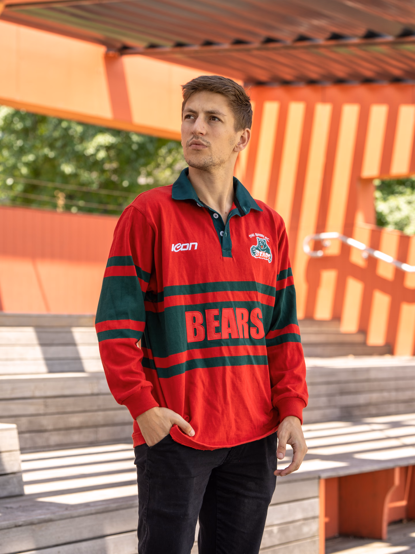 Model wearing a red and green Icon Sports club rugby top