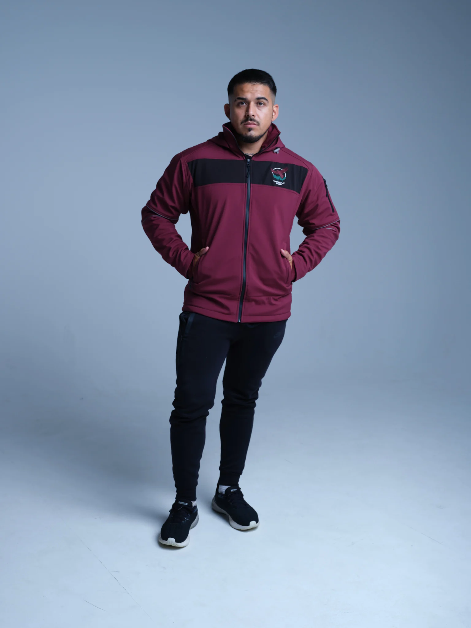 Model wearing a burgundy and black Icon Sports training jacket